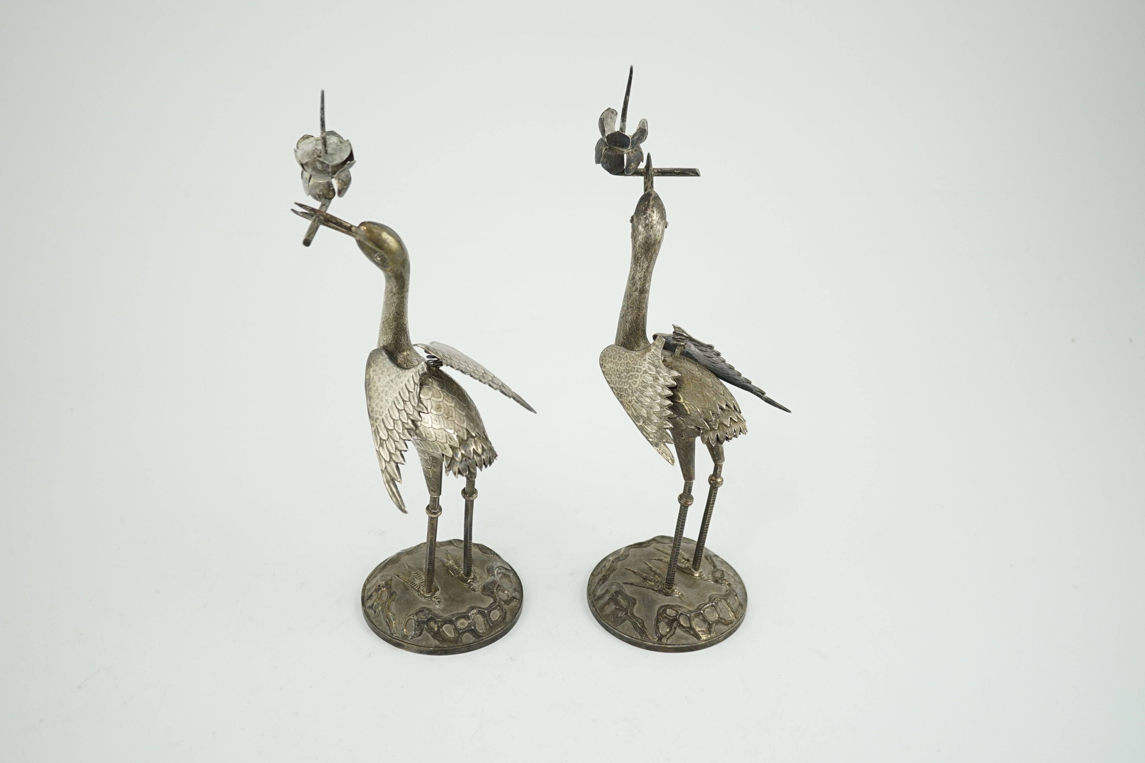 A pair of early to mid 20th century Japanese silver candlesticks, modelled as cranes